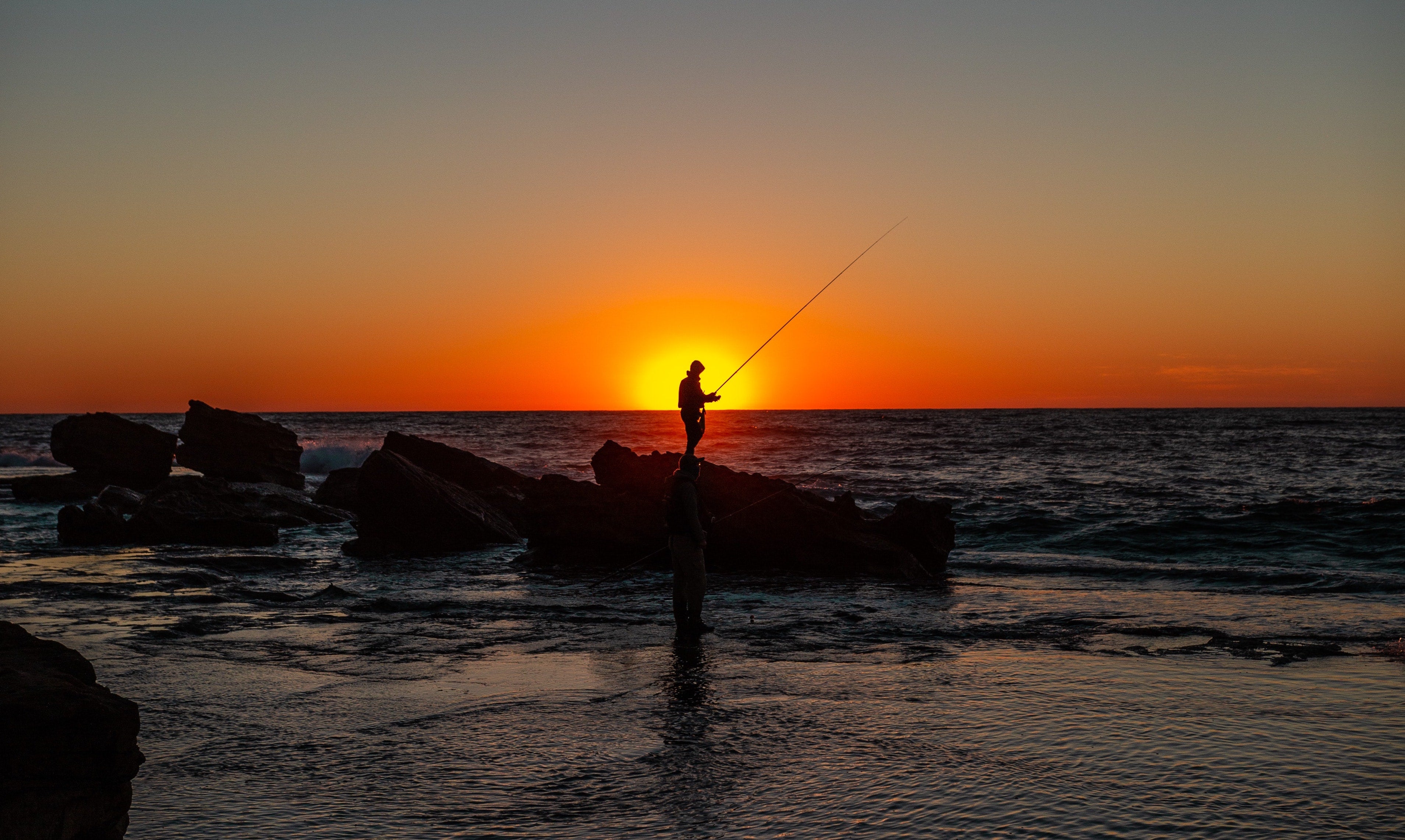 man fishing in the sunset 