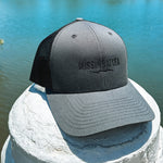 charcoal grey and black trucker hat with black Missing At Sea embroidered logo